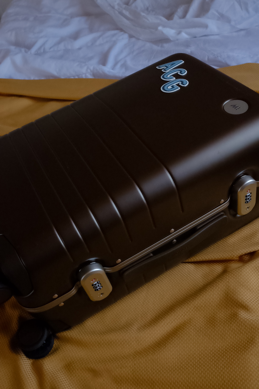 Monos suitcase close-up, showcasing its smooth finish and durable design.